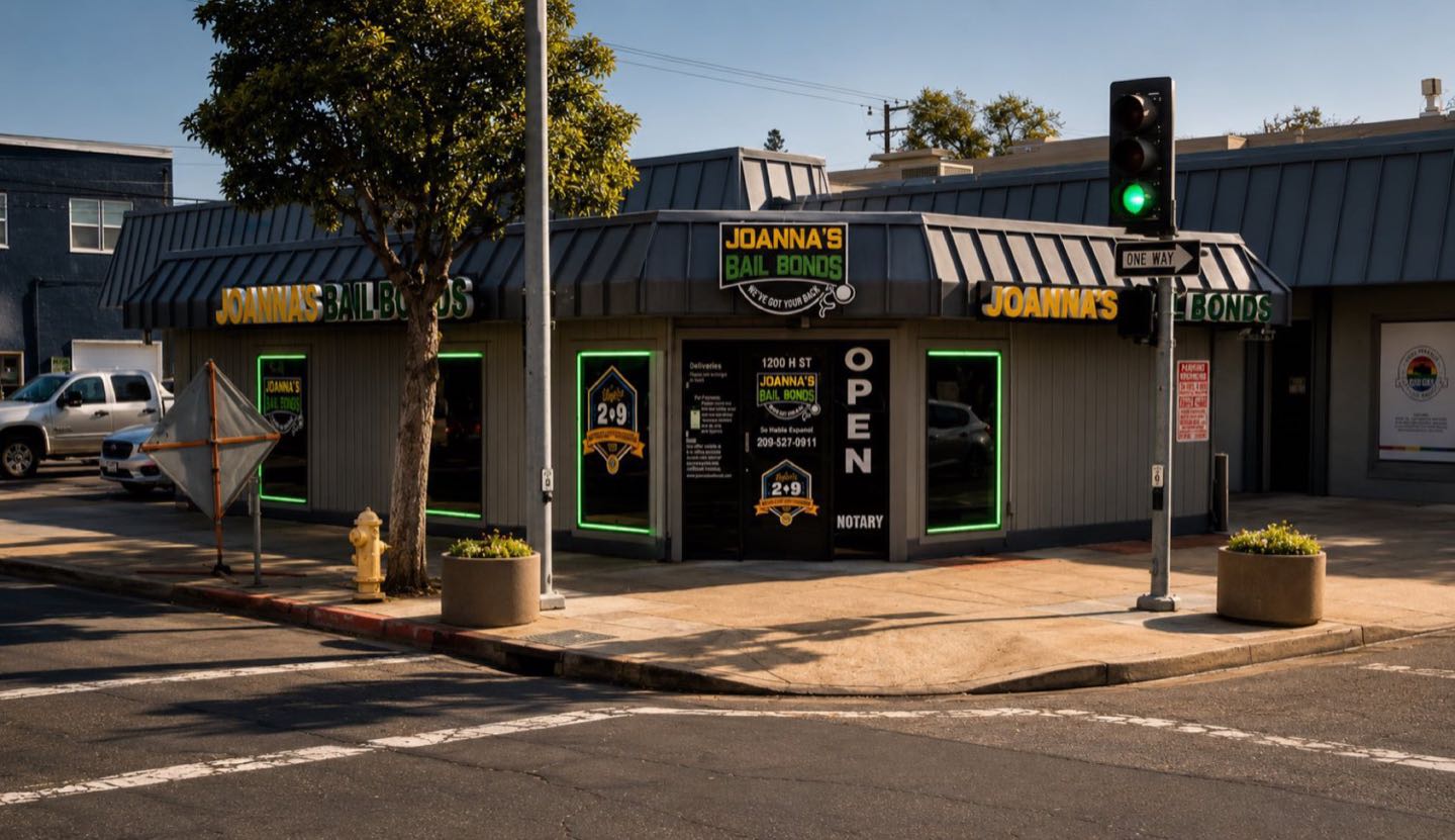 Joanna's Bail Bonds office glowing at dusk on H Street, Modesto
